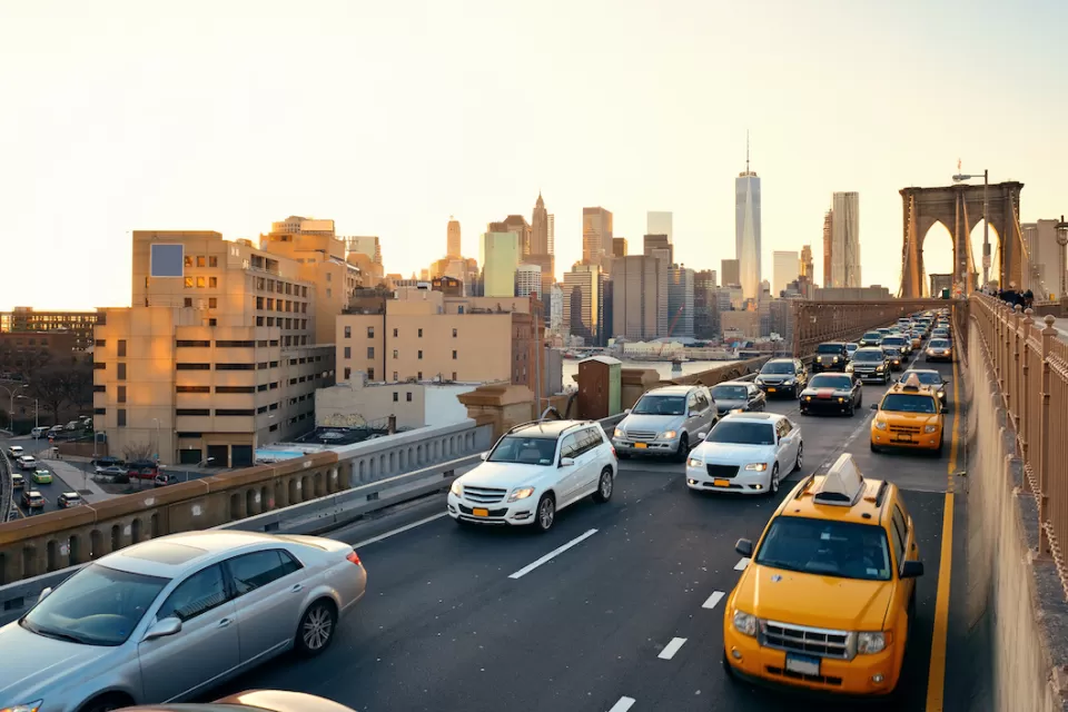 View of rush hour traffic on Brooklyn Bridge at golden hour.